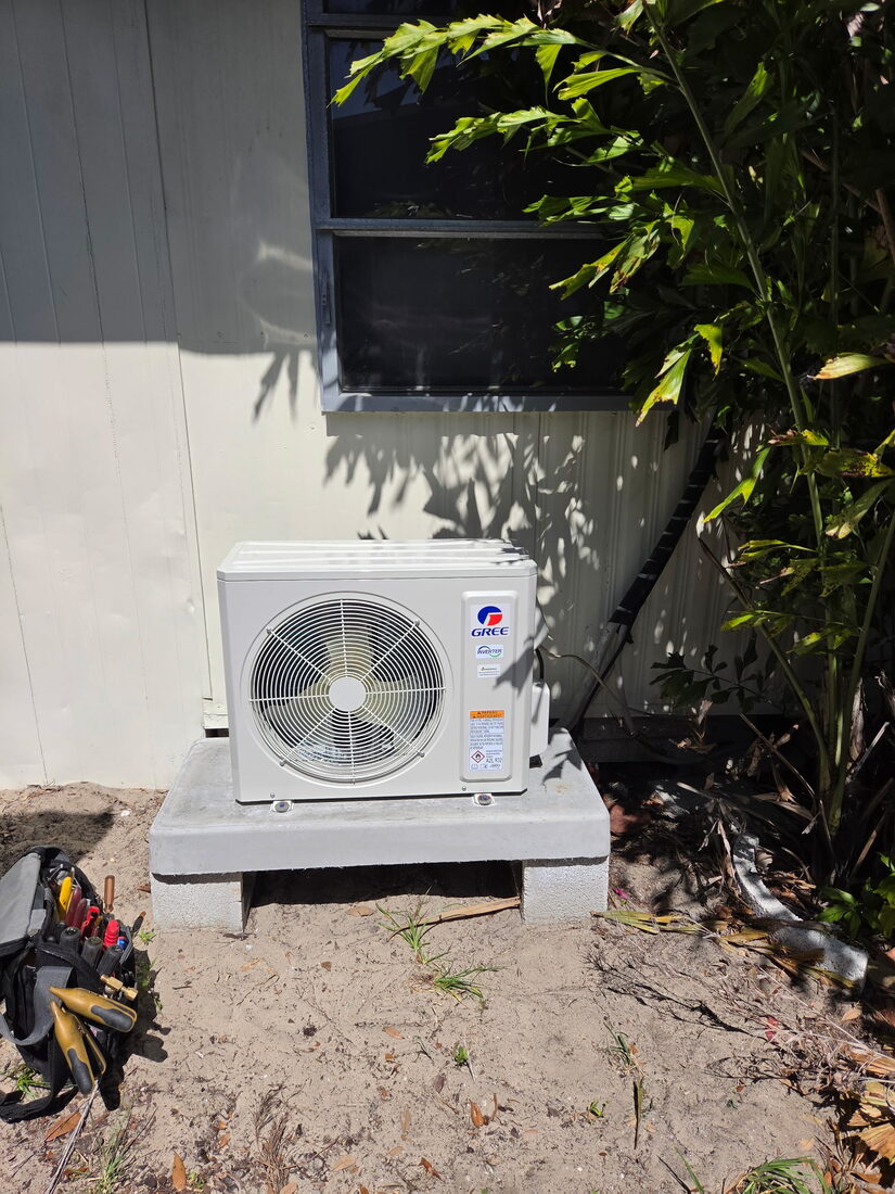 Fritz technician servicing an outdoor AC unit